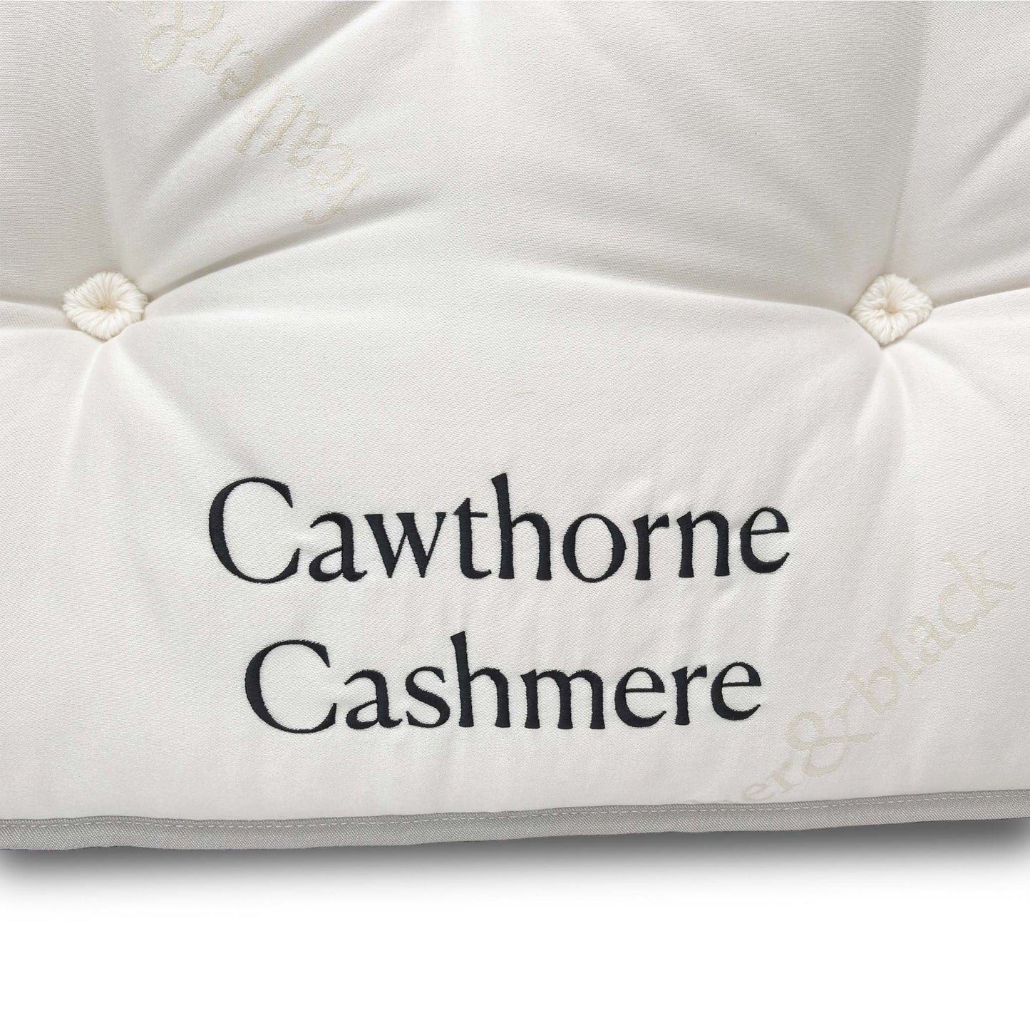 Close-up of the strong, upholstered turning handles on the mattress side, designed to assist with rotating the deep-fill mattress.