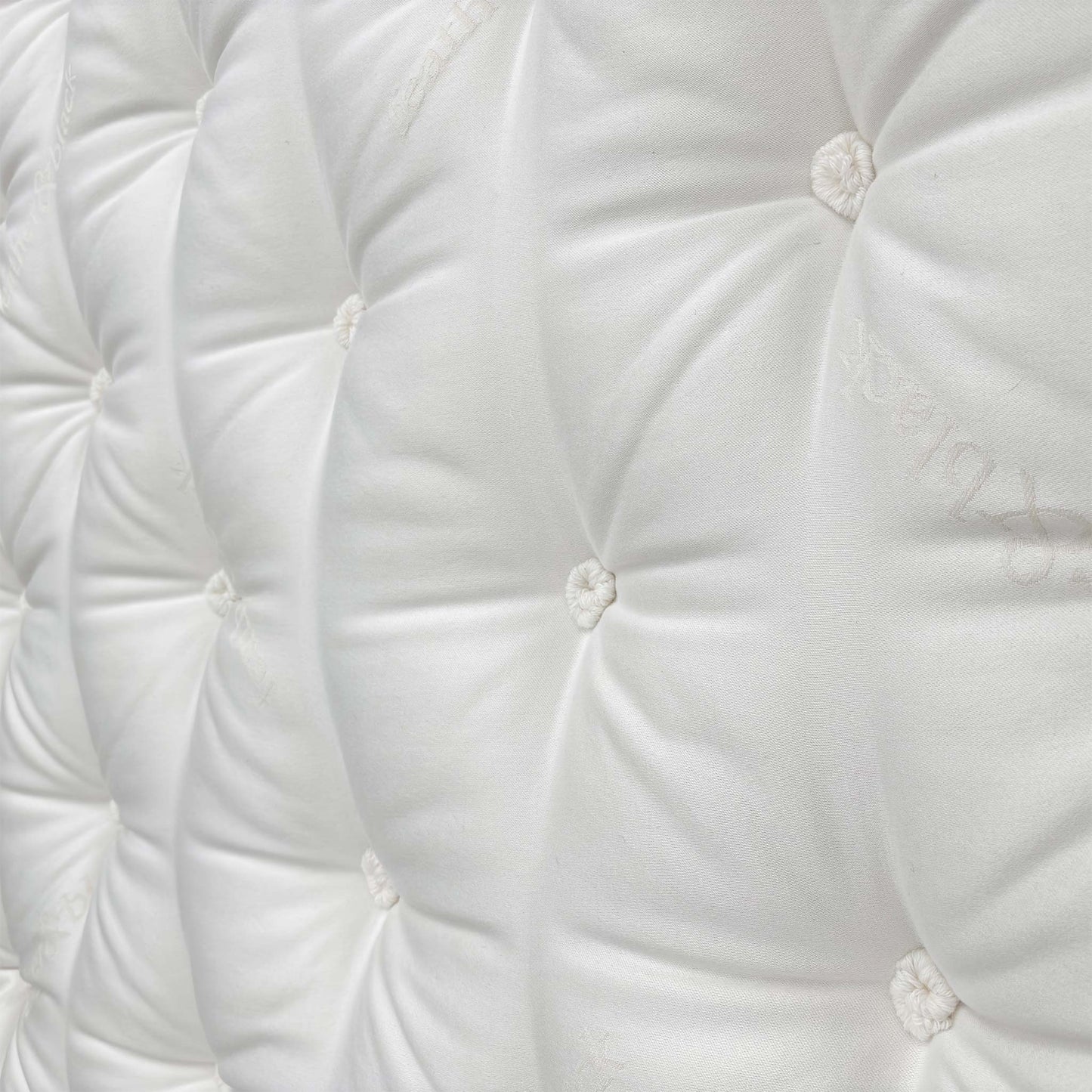 Detailed close-up of the sumptuous Pillow Top sleeping surface, emphasizing the comfort layer and the natural materials like cashmere and wool.
