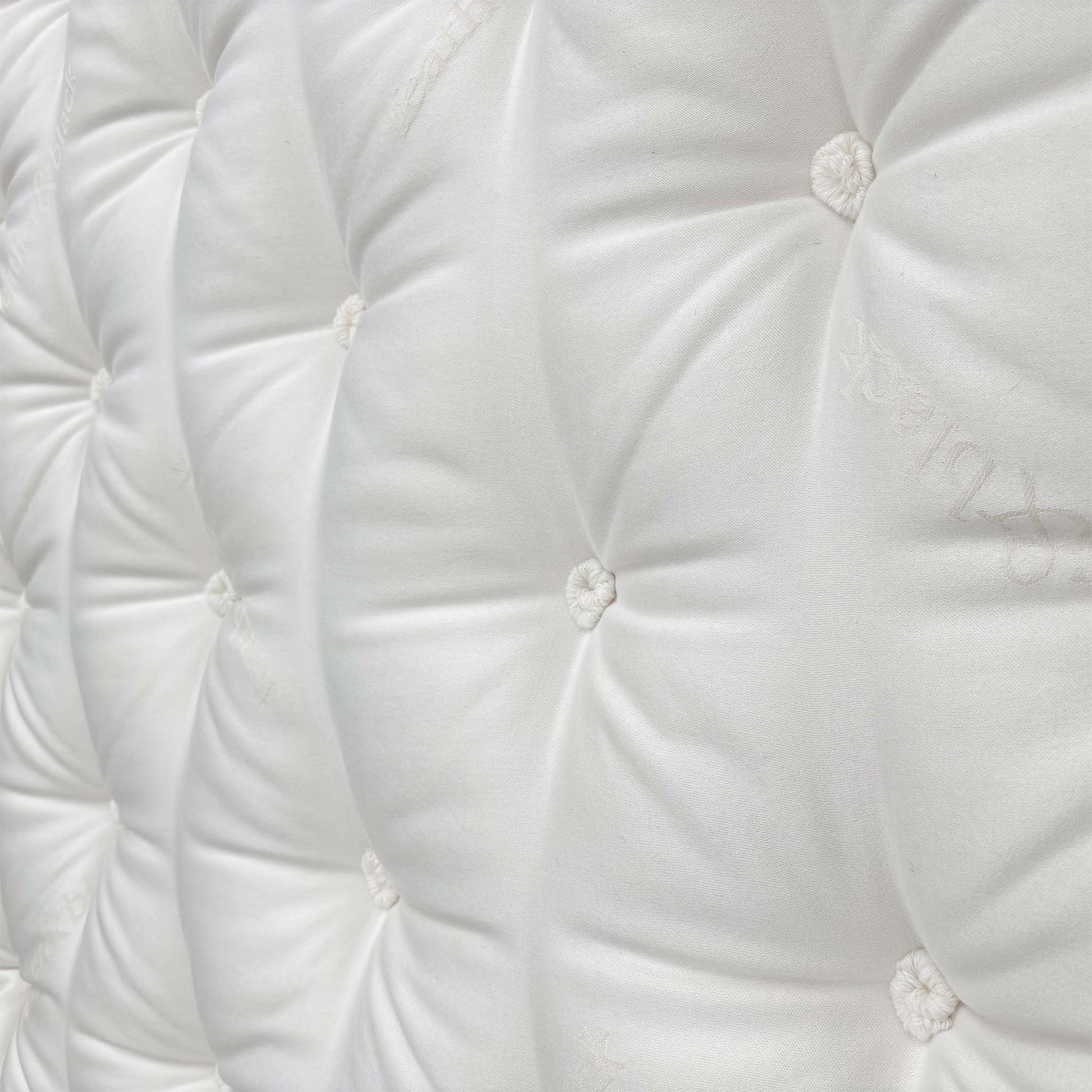 Detailed close-up of the sumptuous Pillow Top sleeping surface, emphasizing the comfort layer and the natural materials like cashmere and wool.