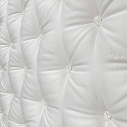 Detailed close-up of the sumptuous Pillow Top sleeping surface, emphasizing the comfort layer and the natural materials like cashmere and wool.