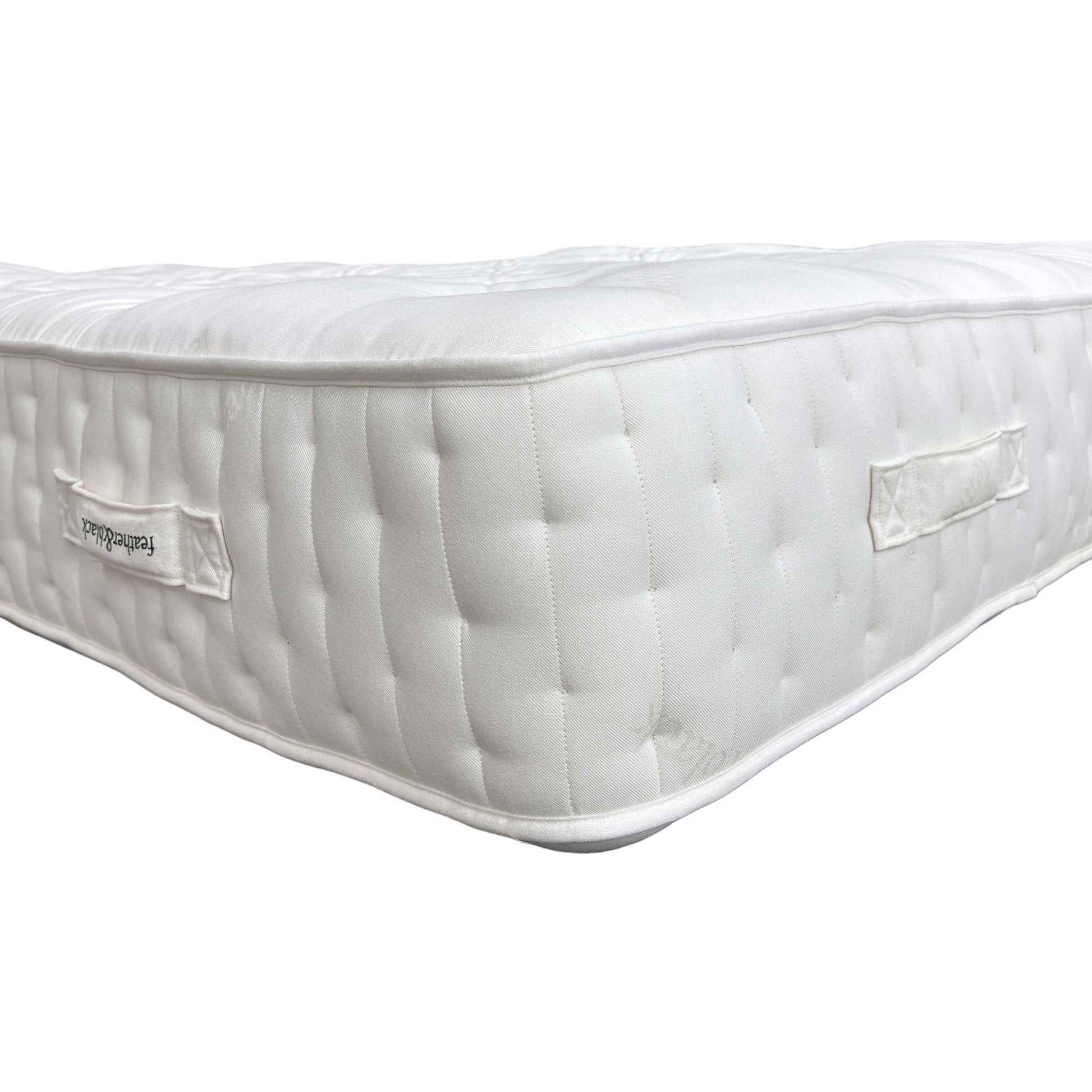 Close-up of the official Harrison Spinks / Feather & Black branding label and tag, confirming the high 20,000 spring count.