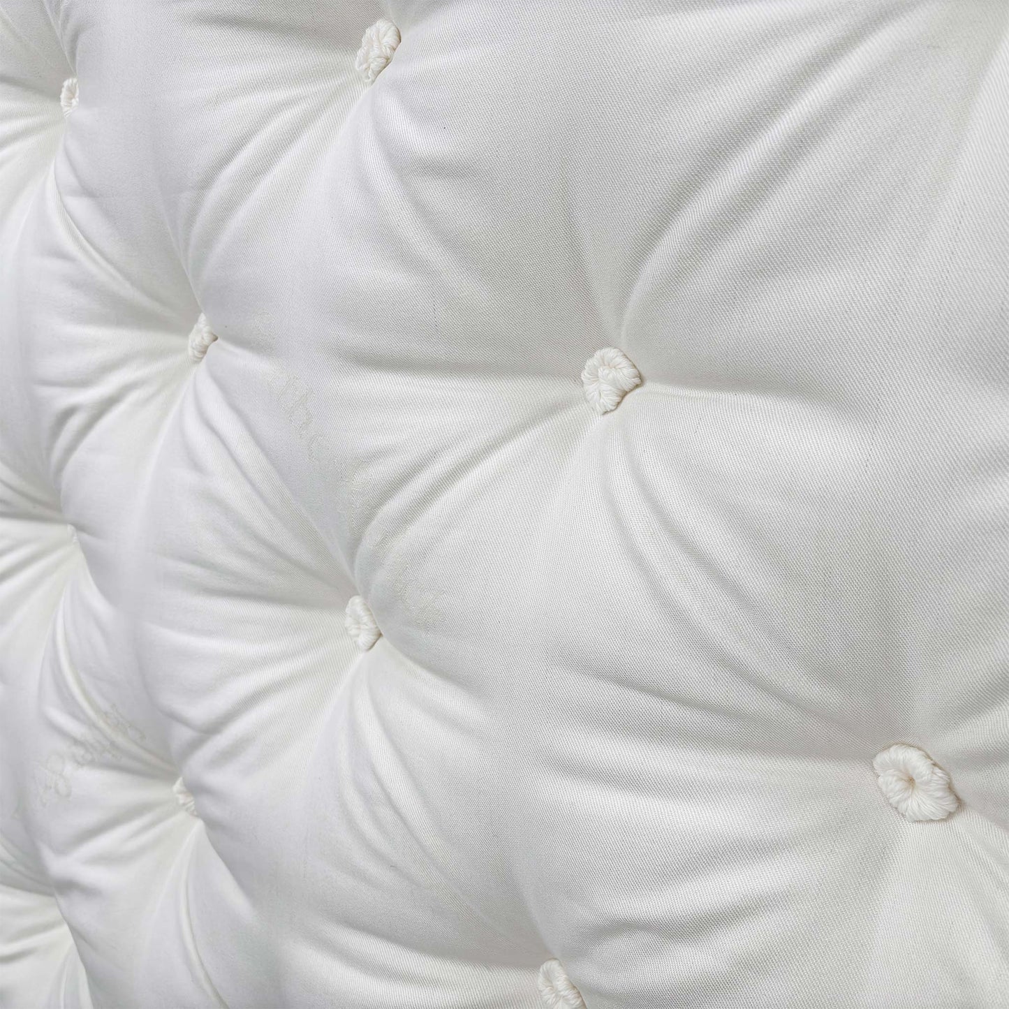 Detailed close-up of the luxurious pillow-top surface, showcasing the natural comfort layers including silk, cashmere, British wool, mohair, and cotton.