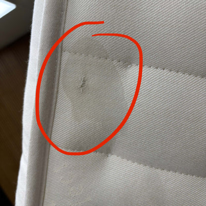 Second close-up image showing a different area of cosmetic damage or imperfection on the mattress fabric/border.