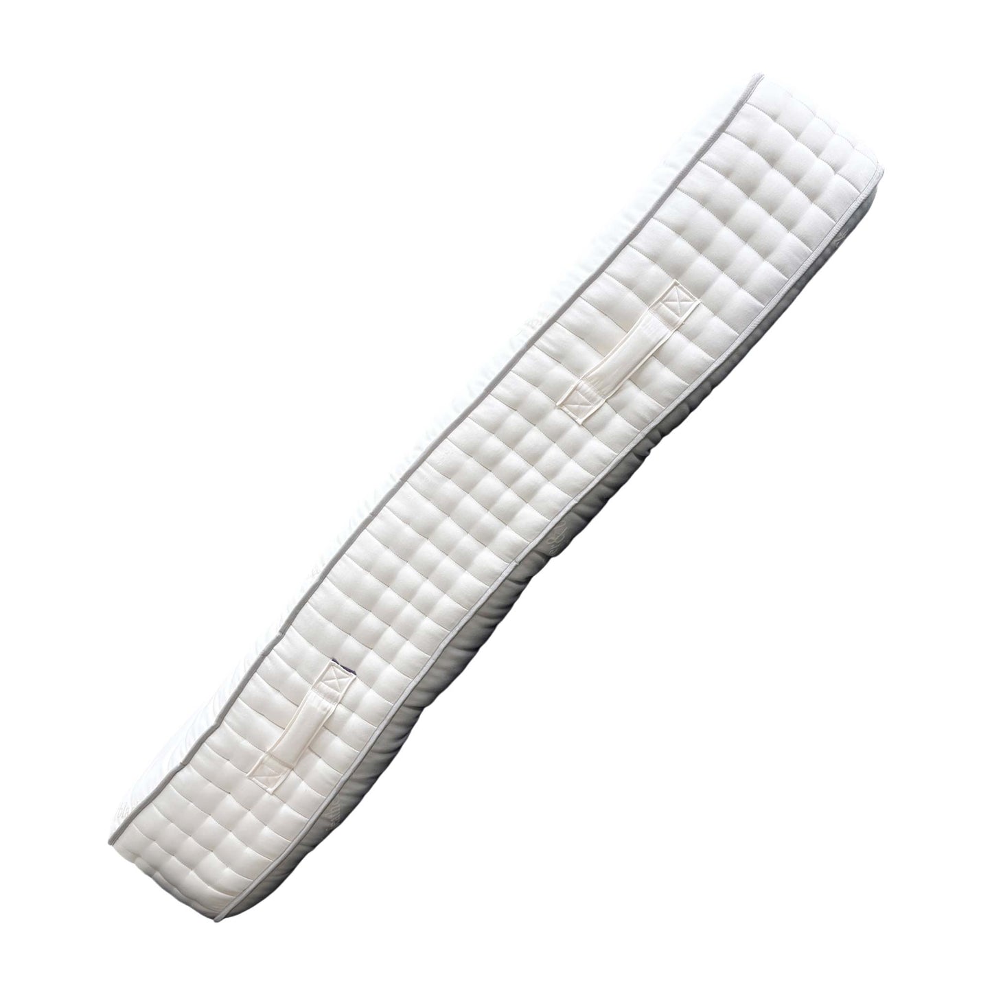 Angled view of the Saxton Silk mattress, highlighting its robust structure, deep profile, and high-quality, breathable white fabric ticking.