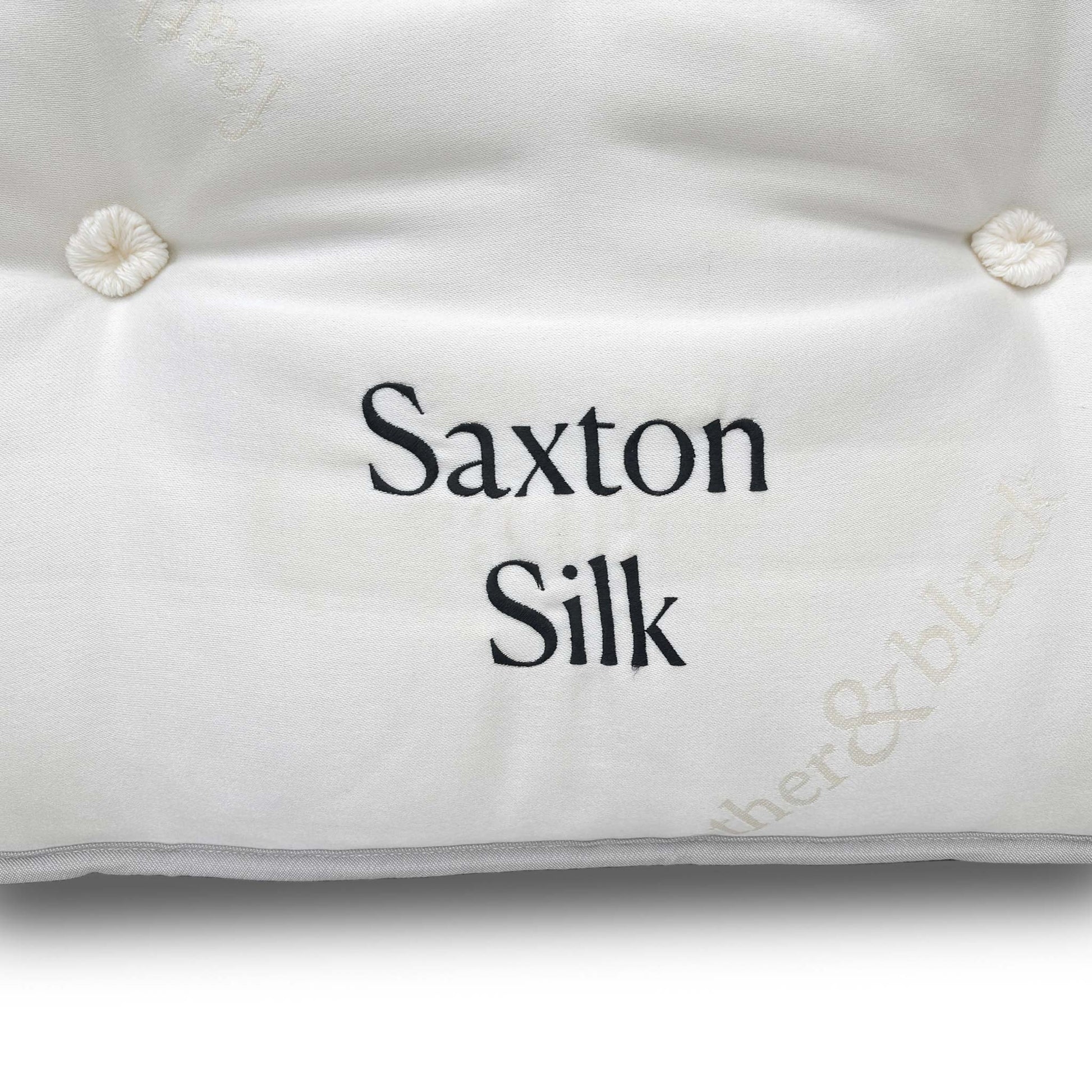 View of the mattress on a bed base, emphasizing its substantial and luxurious 32 cm thickness and the elegant pillow-top design.