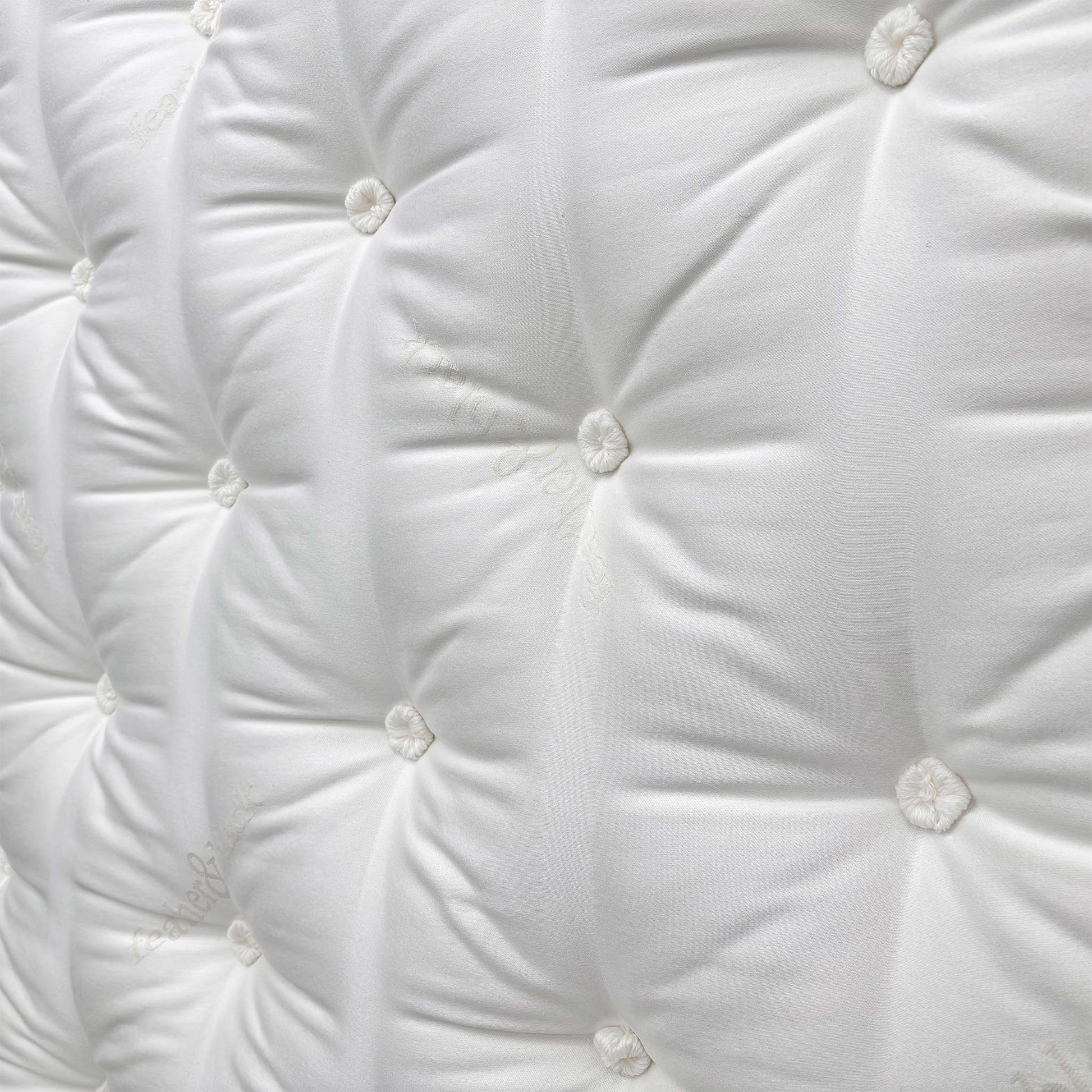 Close-up shot of the center of the mattress, indicating the Split Tension (Medium + Firm) design for personalized comfort on each half.