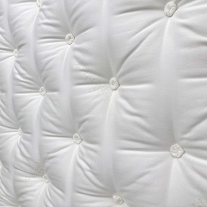 Close-up shot of the center of the mattress, indicating the Split Tension (Medium + Firm) design for personalized comfort on each half.