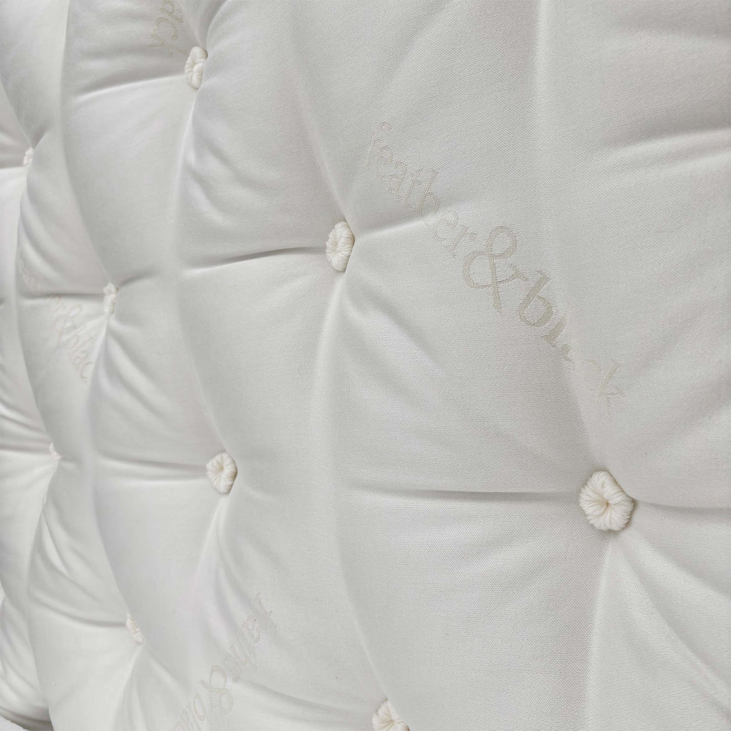 Close-up of the mattress corner showing the stitching/label.