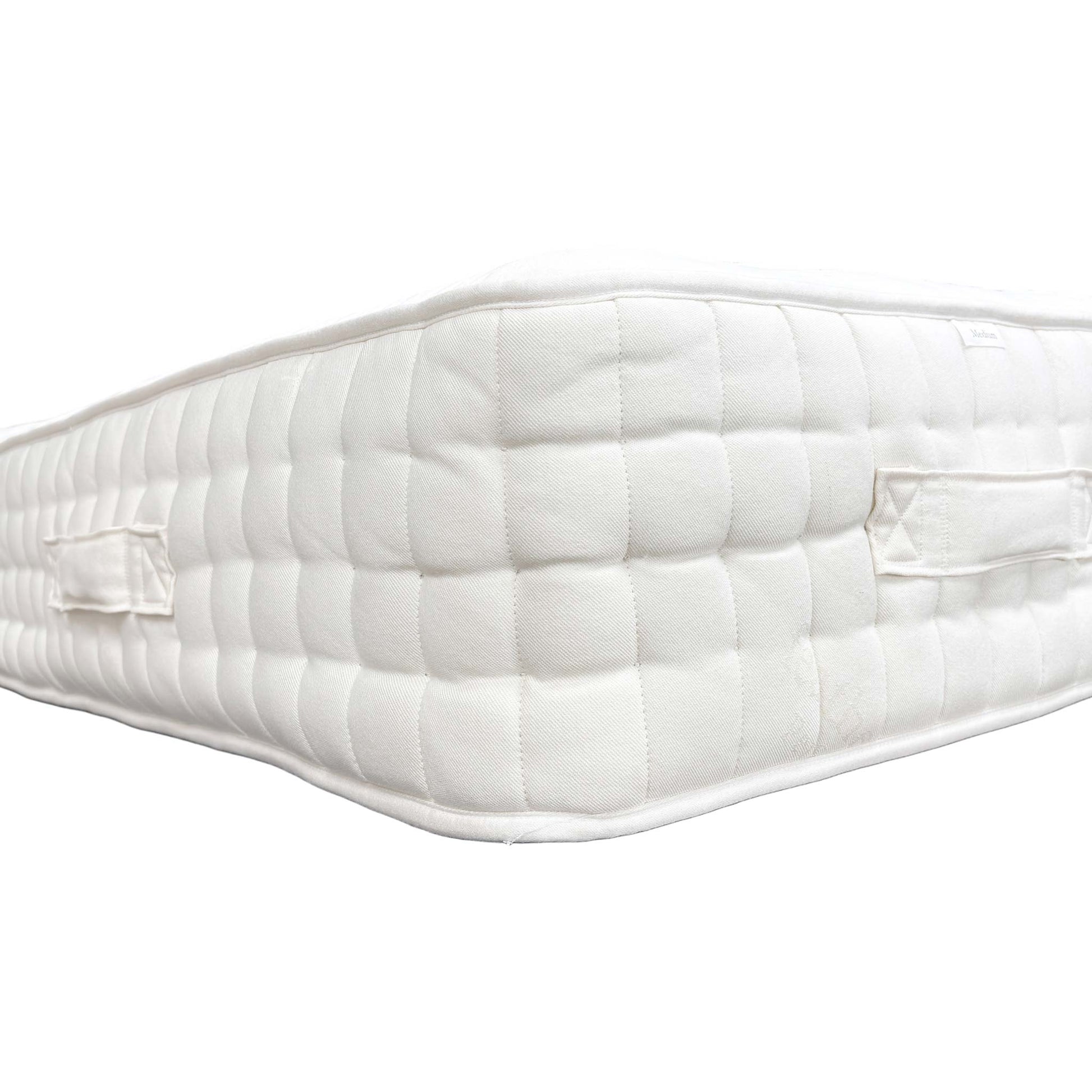 Side view of the mattress on a bed base, showing the depth.