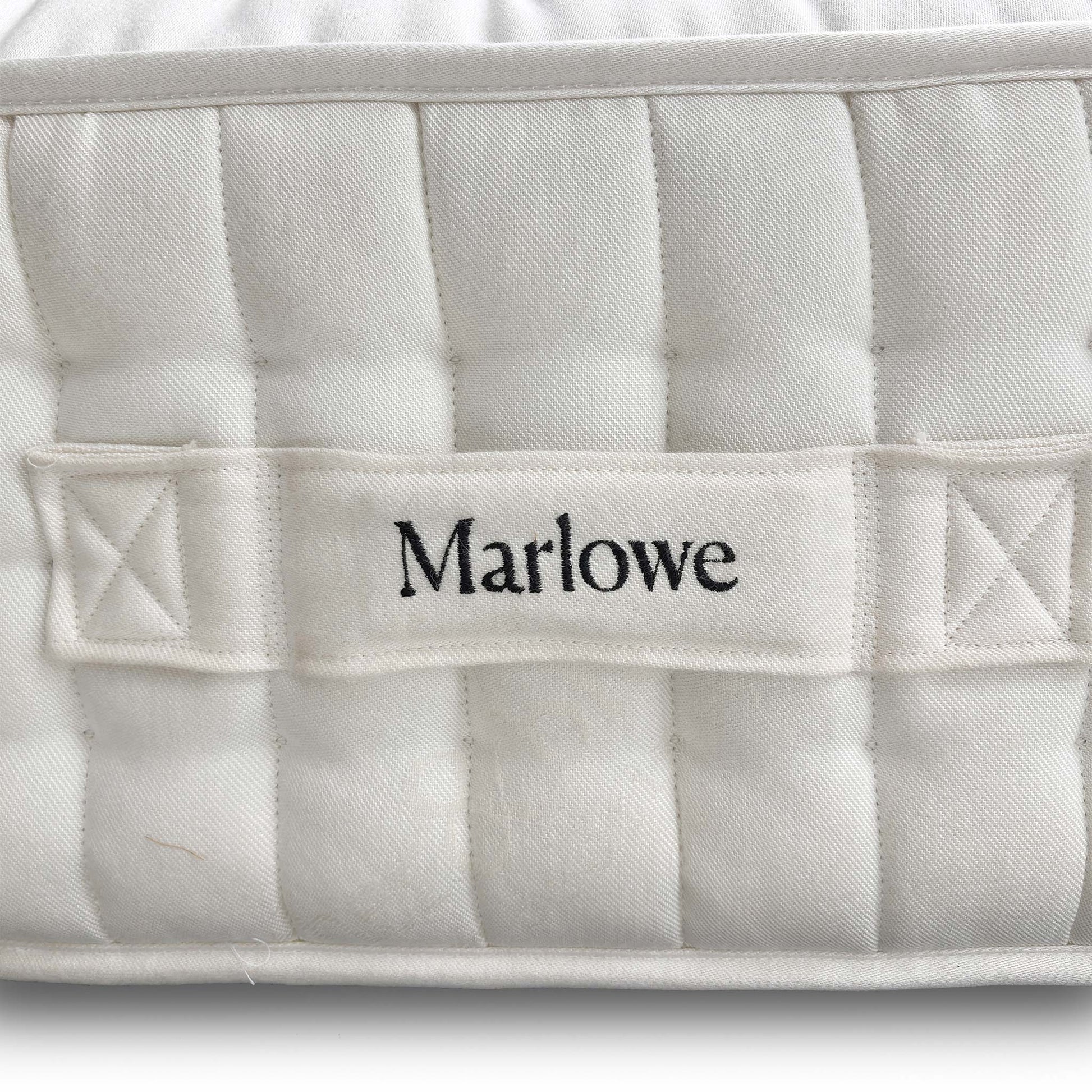 Close-up of the official Harrison Spinks / Feather & Black branding label and tag, confirming the high 12,000 spring count.