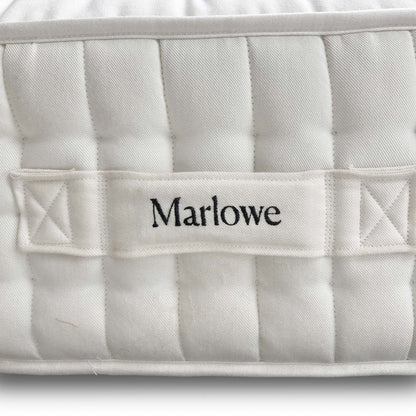 Close-up of the official Harrison Spinks / Feather & Black branding label and tag, confirming the high 12,000 spring count.