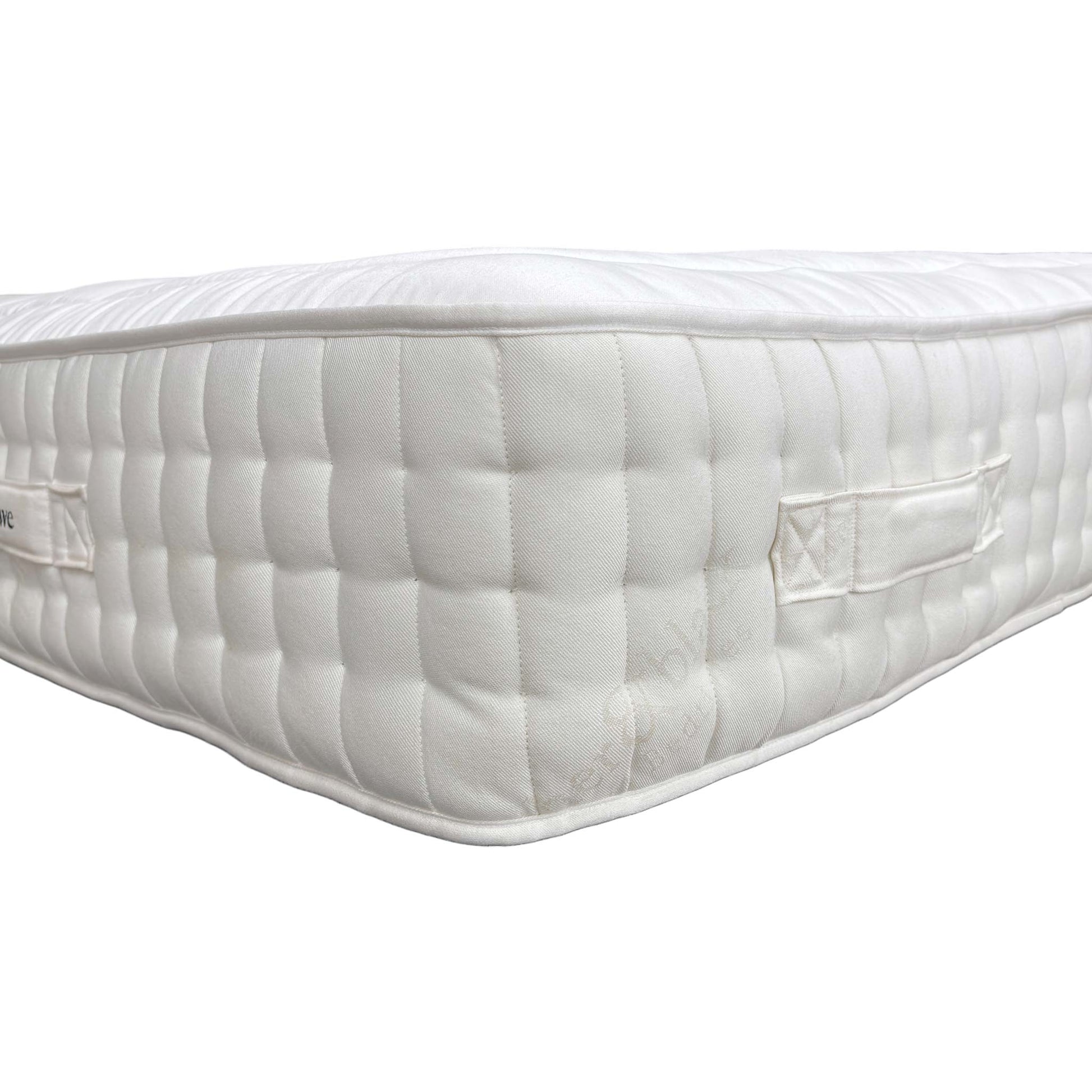 Detailed close-up of the premium white, breathable fabric ticking and the fine stitching detail on the mattress sleeping surface.