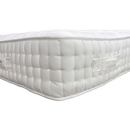 Detailed close-up of the premium white, breathable fabric ticking and the fine stitching detail on the mattress sleeping surface.