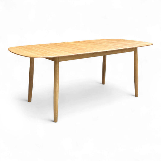 Full view of the 'Stockholm' Light Oak Extending Dining Table fully extended to 200 cm, showing the light wood tone and flared angled legs.