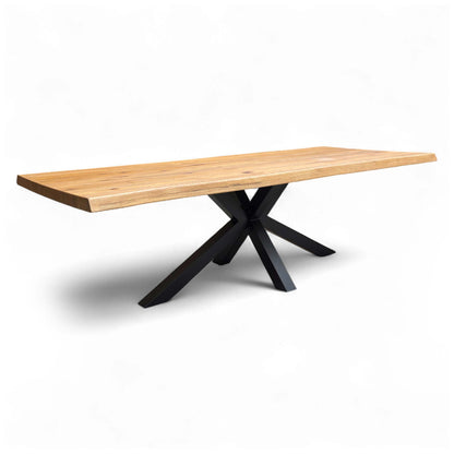 Angled view showcasing the rustic grain and oiled finish of the solid oak tabletop, with the striking, industrial metal star base visible beneath.