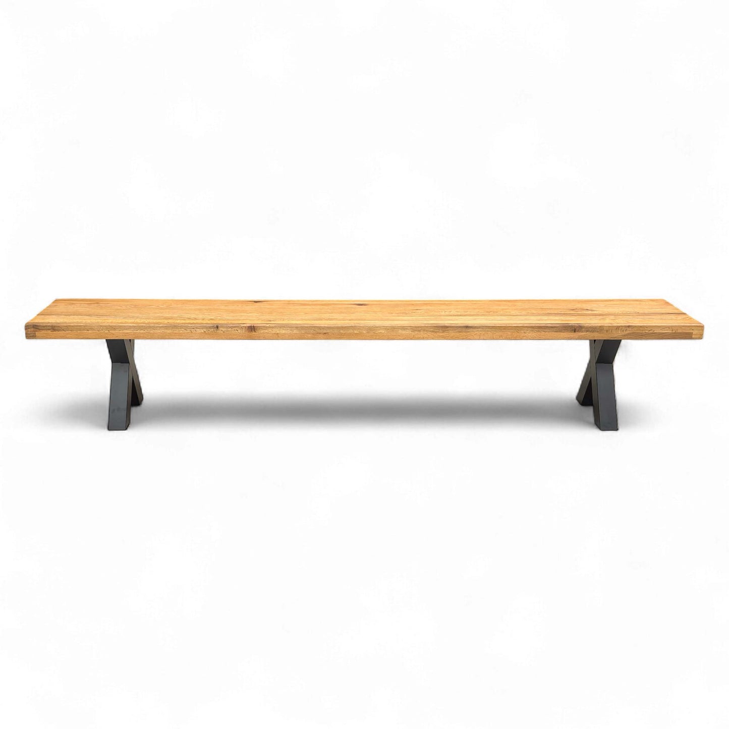 Full length view of the Bodahl Njord 01 dining bench, showcasing the long, solid oiled oak seat and the two metal X-shaped legs.
