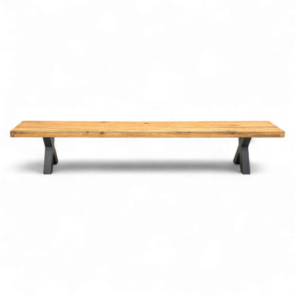 Full length view of the Bodahl Njord 01 dining bench, showcasing the long, solid oiled oak seat and the two metal X-shaped legs.
