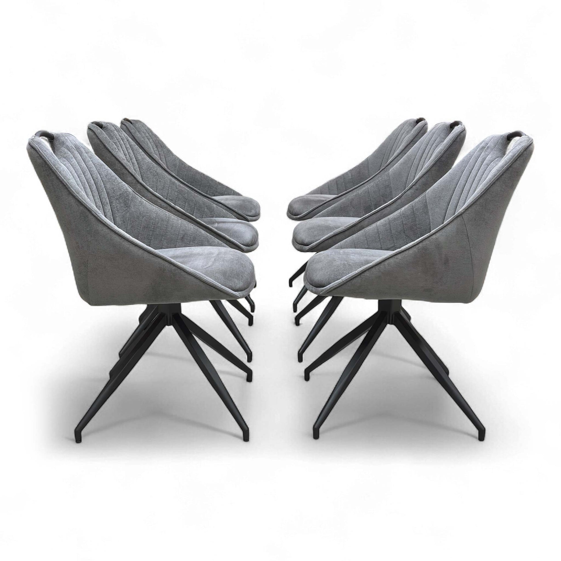 An angled view showing a group of chairs around a dining table (or arranged as a set).