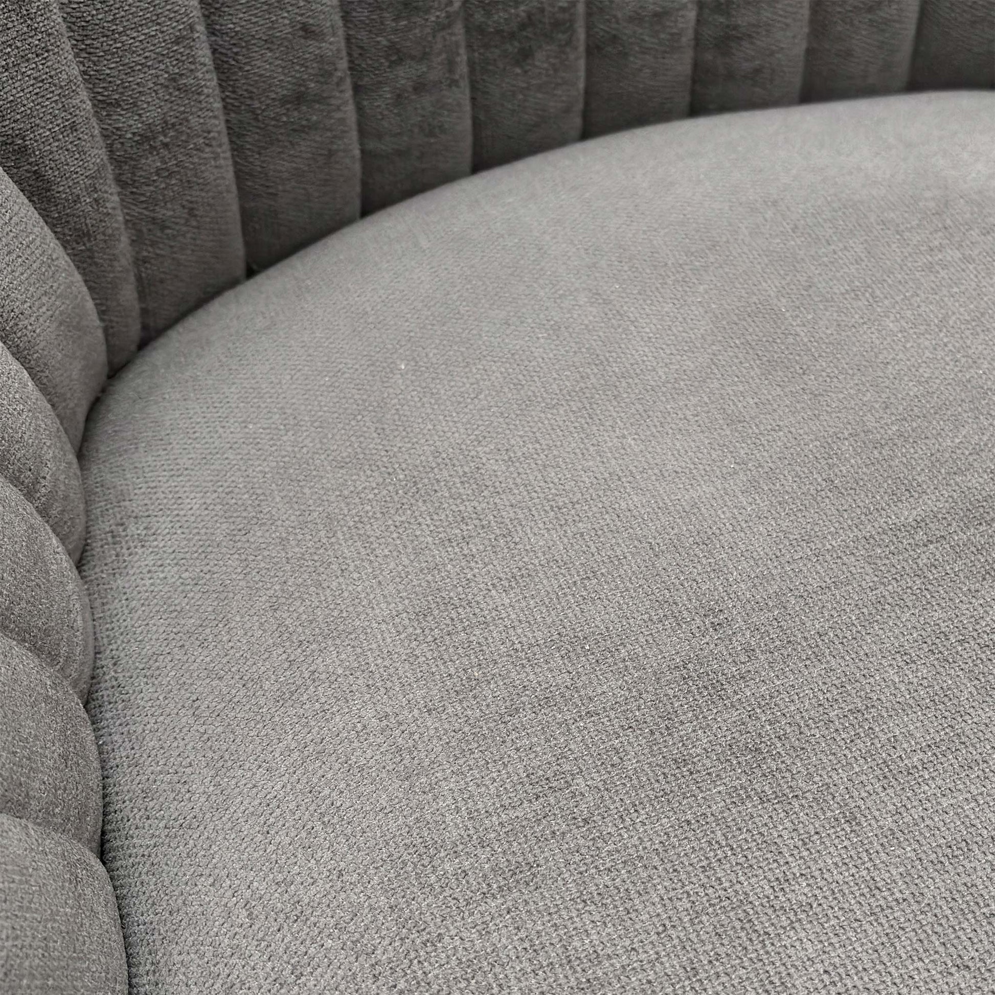 Close-up view of the dark grey fabric texture and the matt black legs.