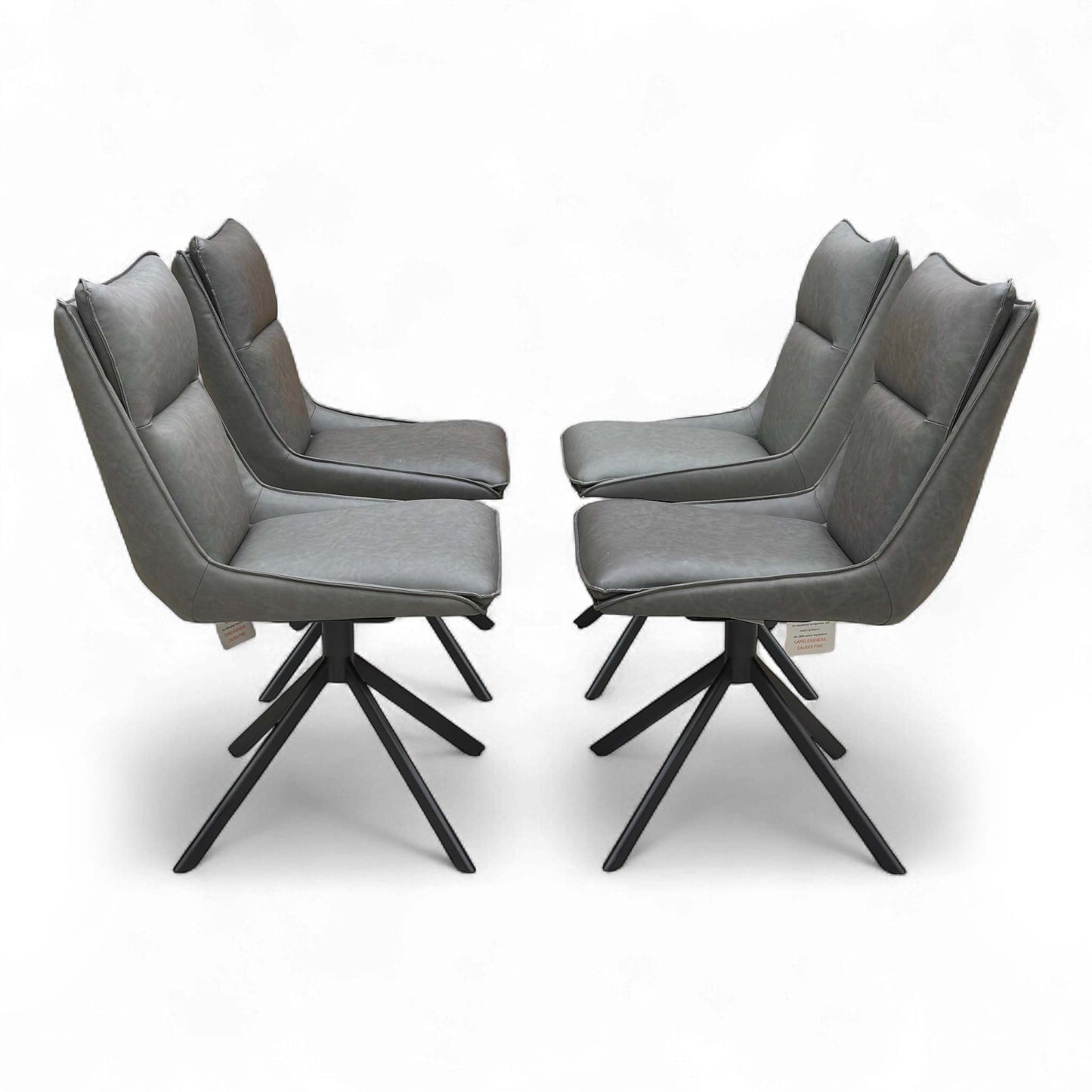 Set of four ‘Catalina’ dining chairs arranged together, demonstrating the dark grey faux leather upholstery and contemporary design.