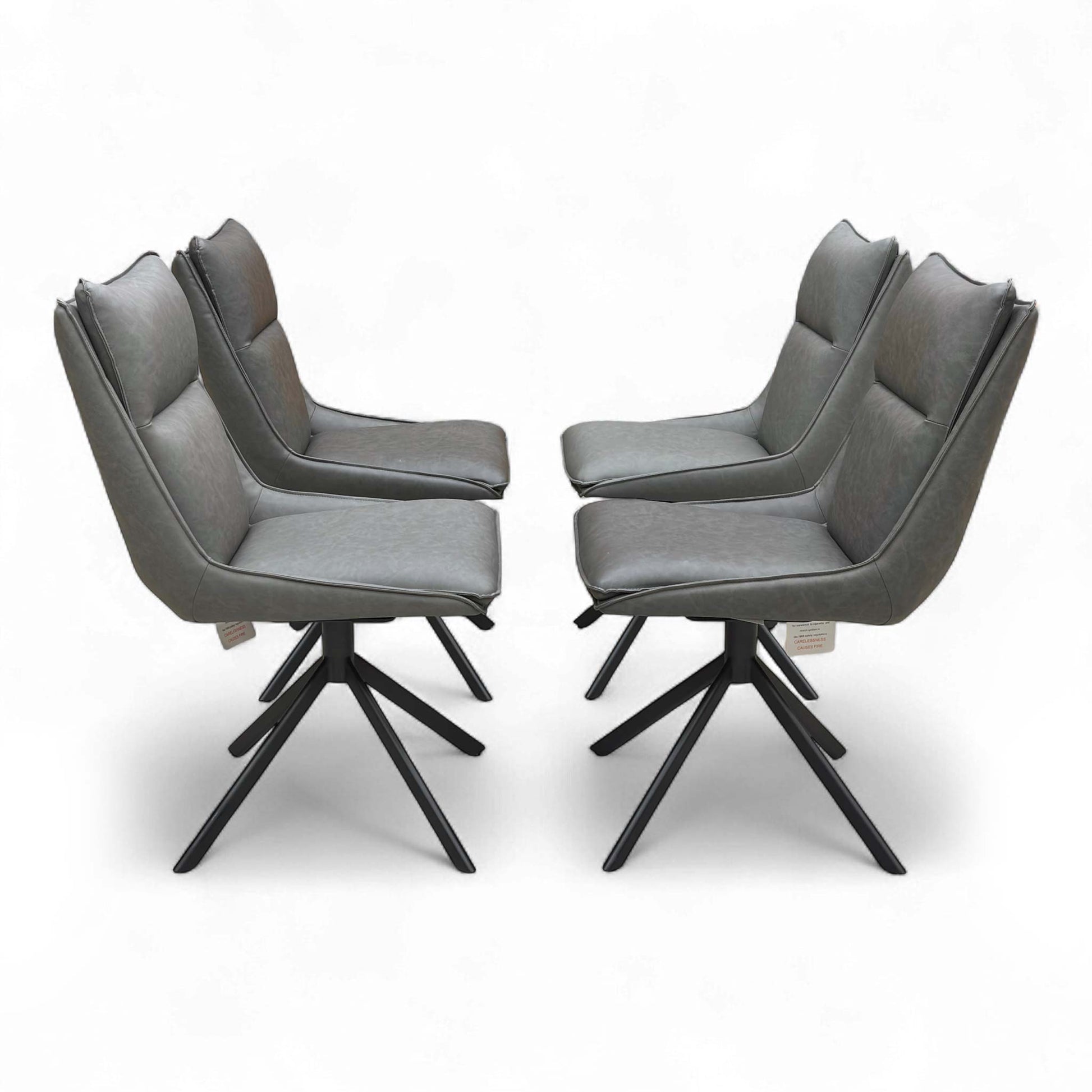 Set of four ‘Catalina’ dining chairs arranged together, demonstrating the dark grey faux leather upholstery and contemporary design.