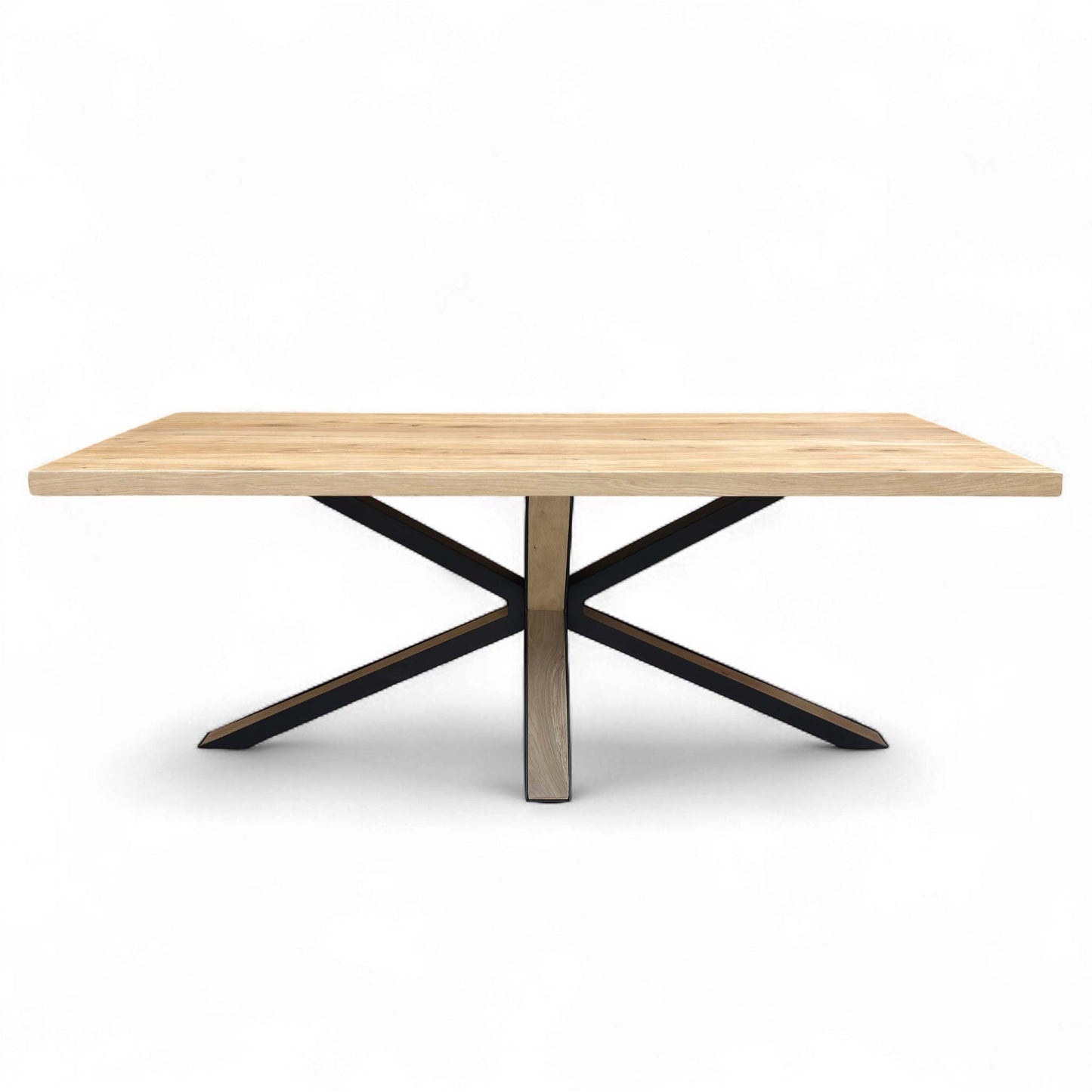 Full view of the rectangular oak dining table with the distinctive starburst leg base.