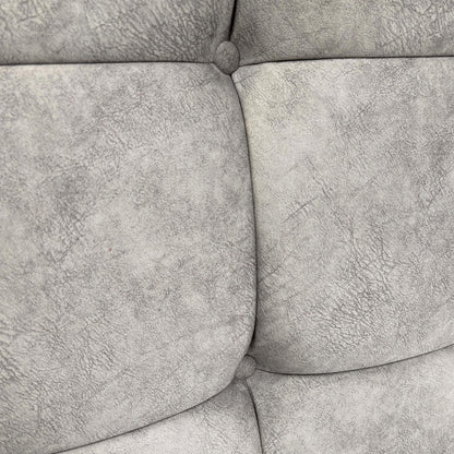 Close-up of the headboard's button-tufting detail.