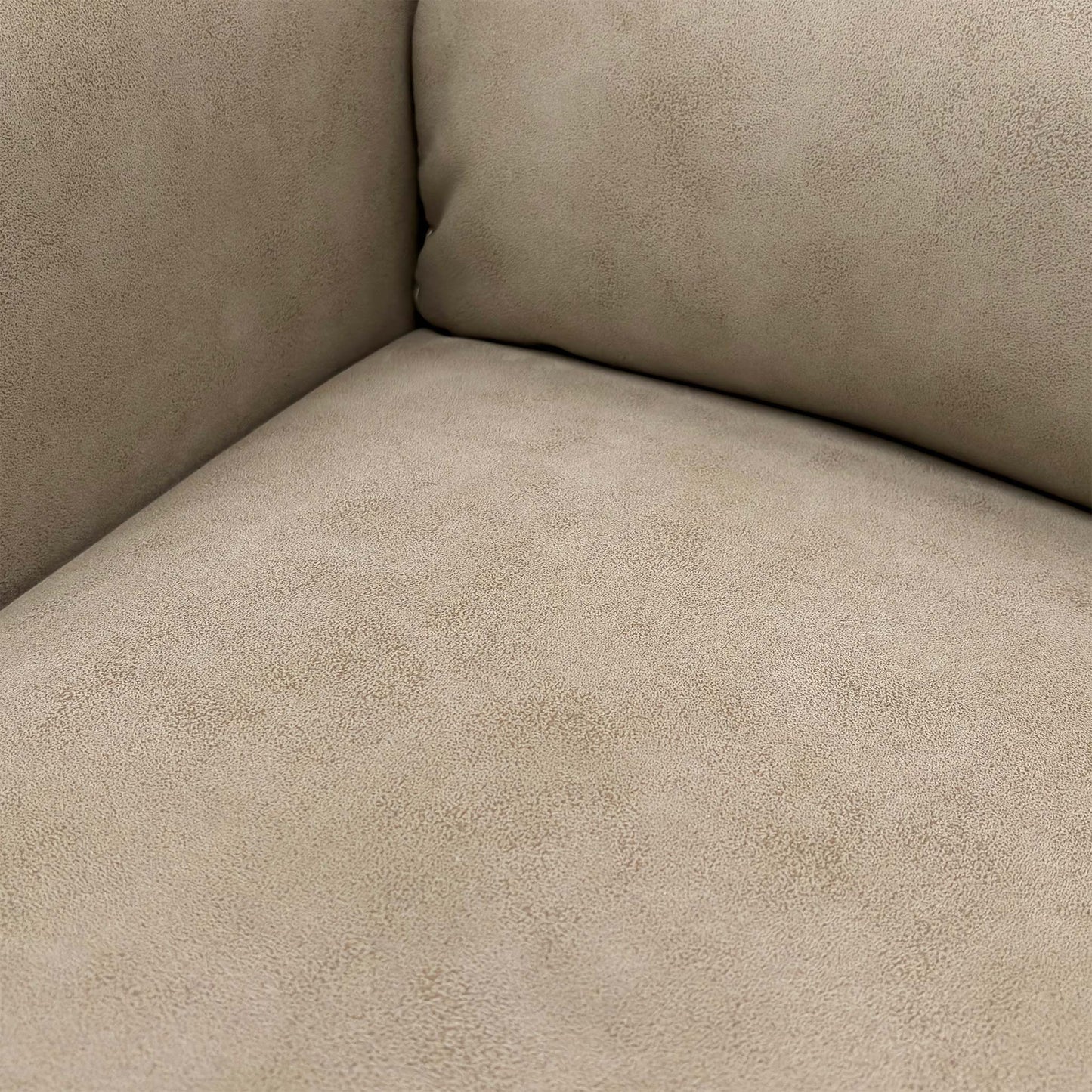 Close-up detail of the stitching and tufting on the Nixon Chair's back cushion, showing the suede fabric texture.