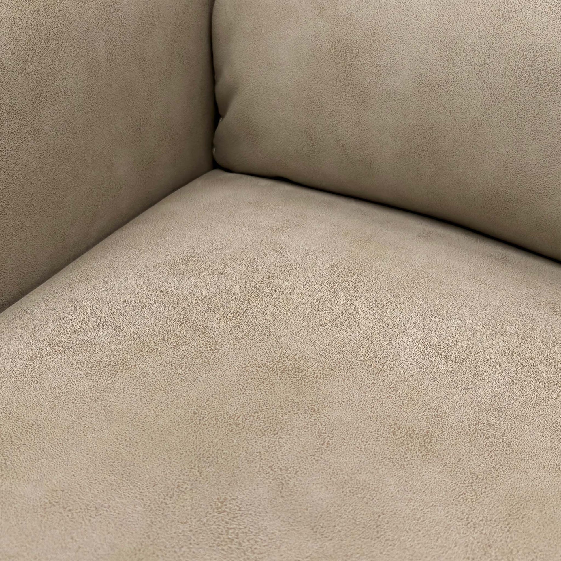 Close-up detail of the stitching and tufting on the Nixon Chair's back cushion, showing the suede fabric texture.
