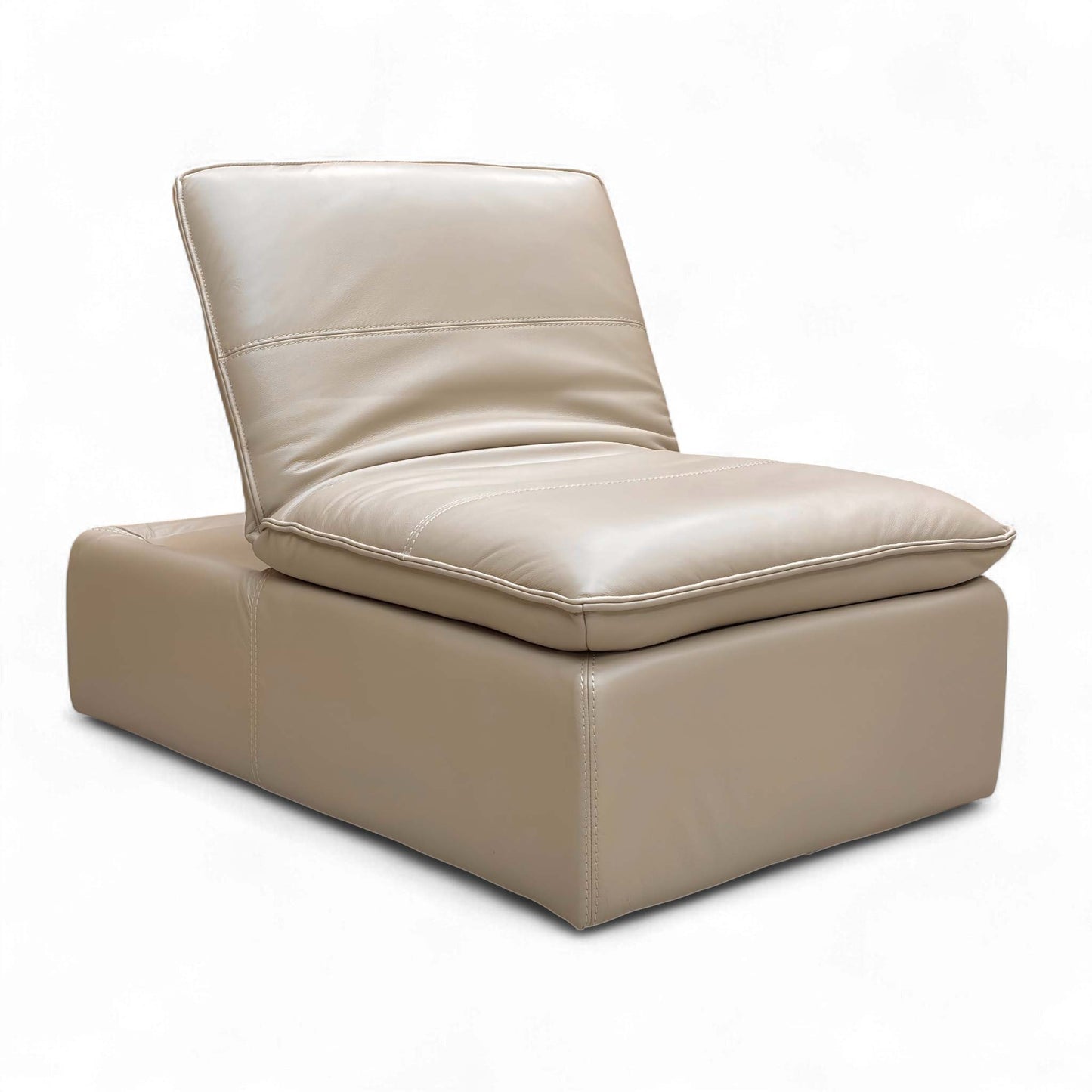 Angled view of the ‘Starlight Express’ Footstool, emphasizing the supple Pebble Cream leather and comfortable medium firmness cushioning.