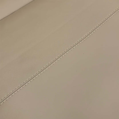 Detailed close-up of the texture and fine stitching on the Pebble Cream Leather upholstery.