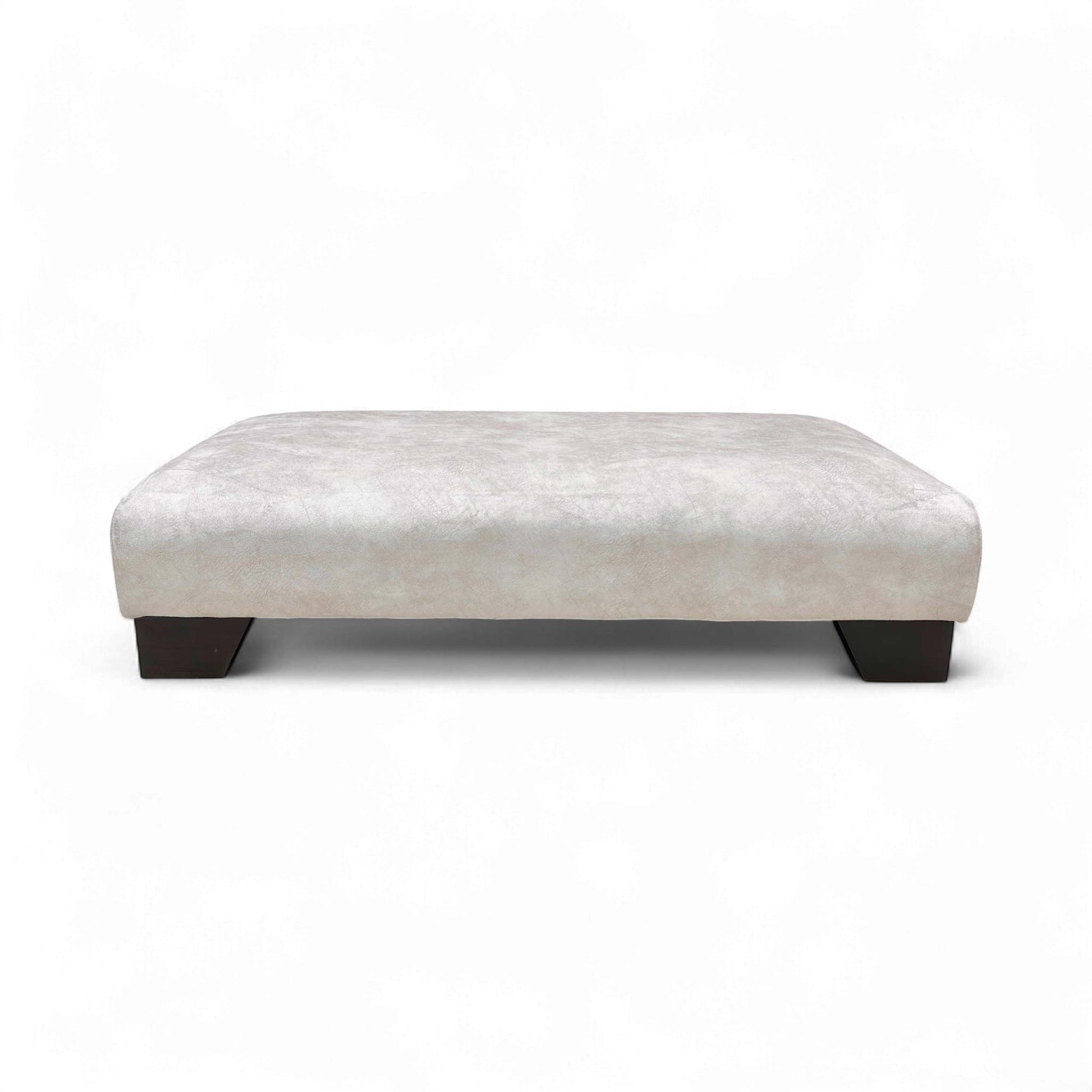 Full, side view of the Kenzo Cream velvet footstool, highlighting its elegant design and low profile.