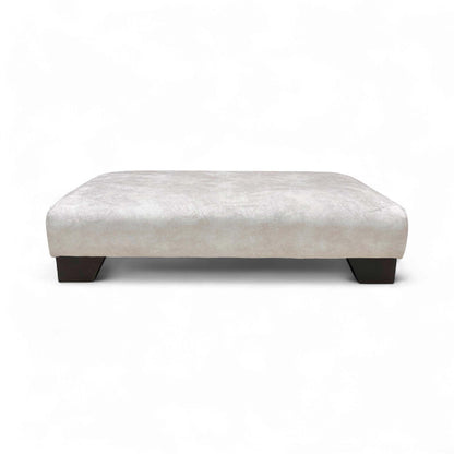 Full, side view of the Kenzo Cream velvet footstool, highlighting its elegant design and low profile.