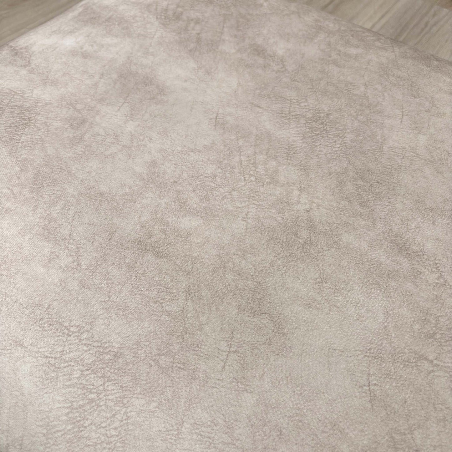 Detailed close-up of the Cream Velvet fabric of the 'Aura' footstool, emphasizing its sophisticated texture.