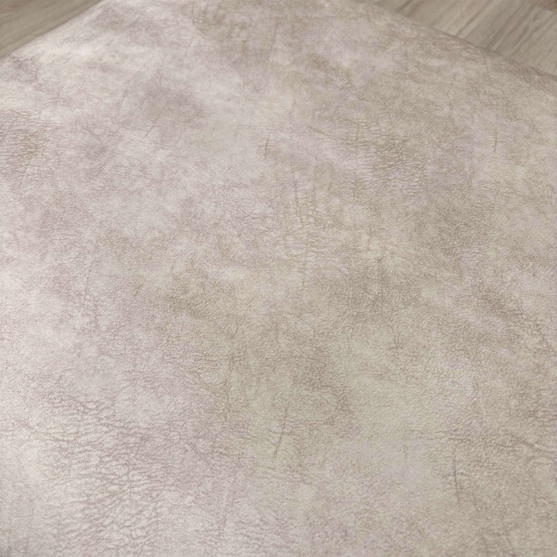 Detailed close-up of the Cream Velvet fabric of the 'Aura' footstool, emphasizing its sophisticated texture.
