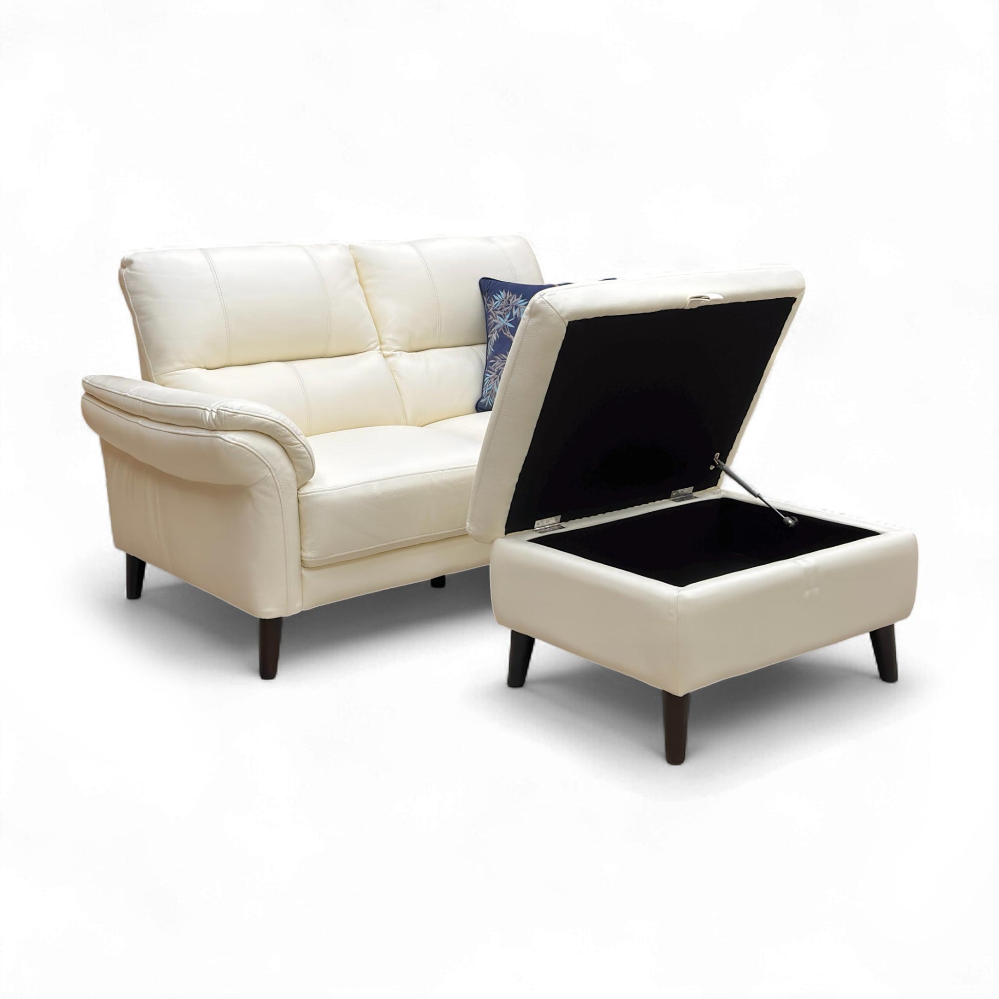 Close-up of the storage footstool with the lid partially open.