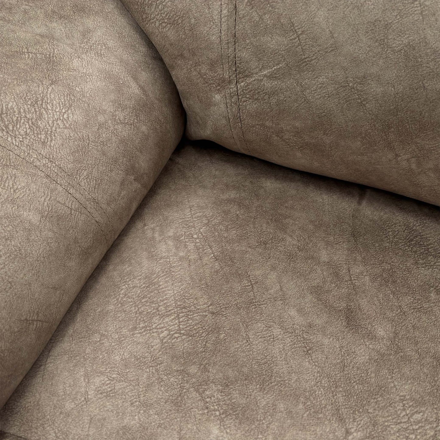 Detail shot of the chair's back and padded armrests, showing the velvet texture.