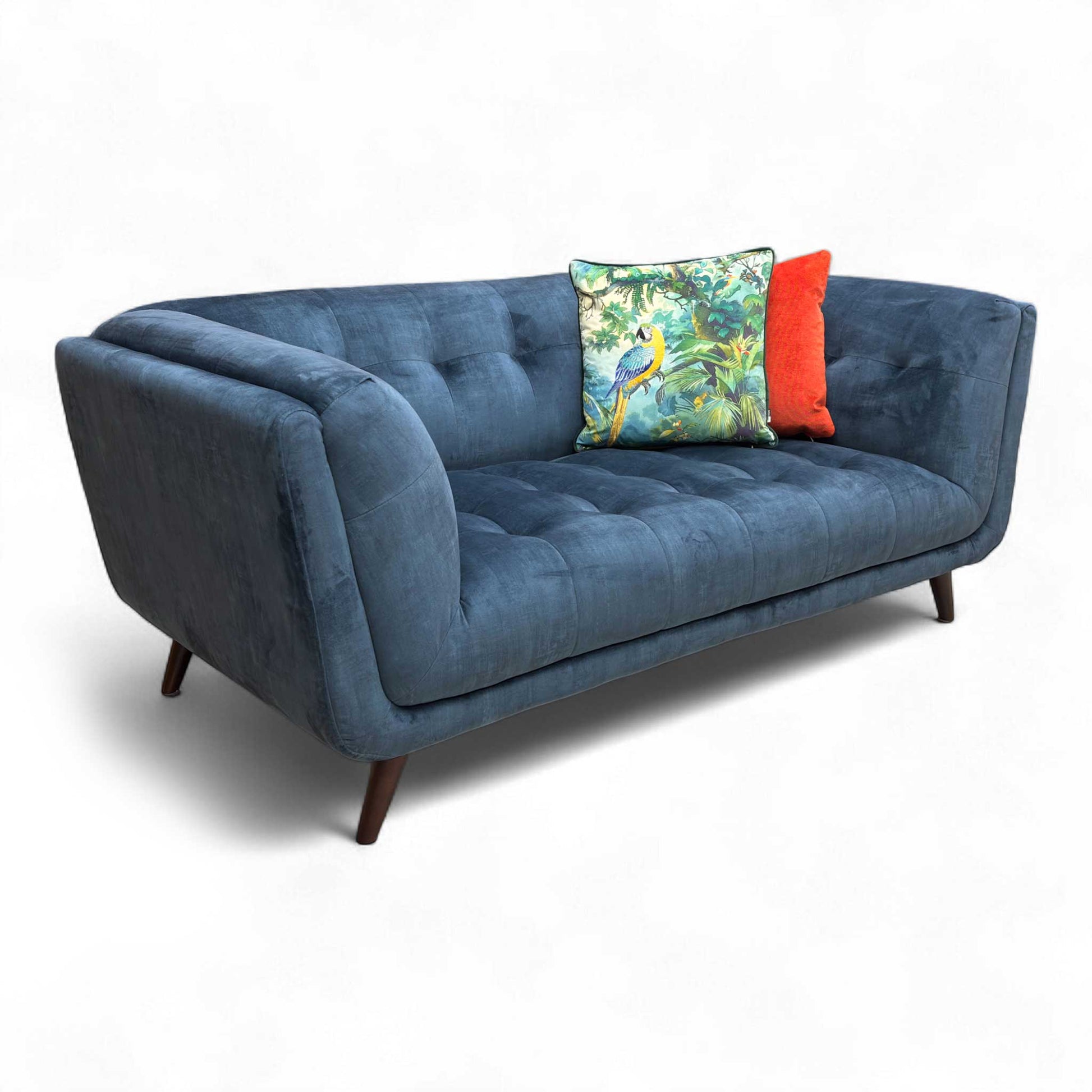 Angled view of the Airforce Blue Velvet sofa, highlighting the contemporary design with distinct sloped arms.