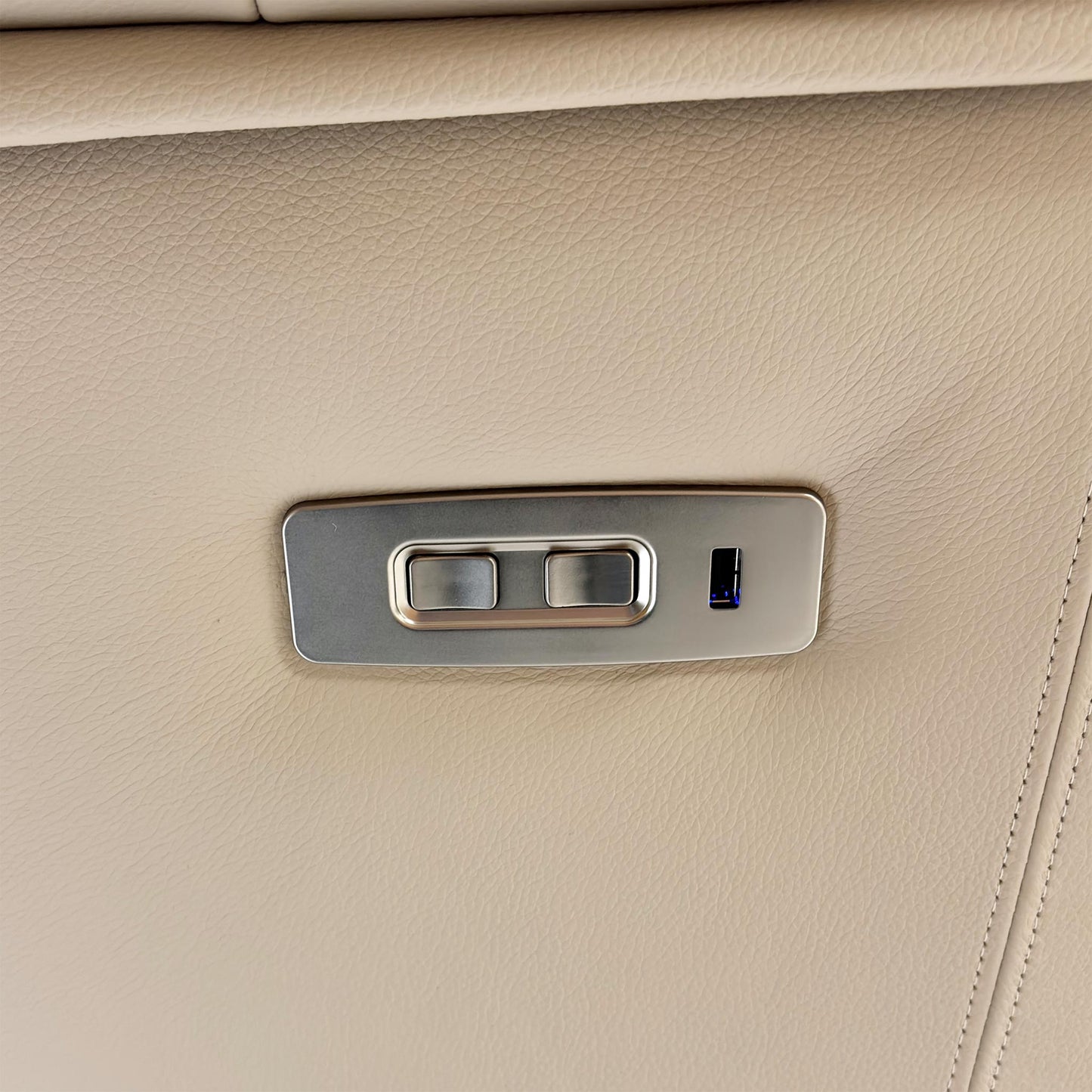 Close-up of the power recliner button on the chair.