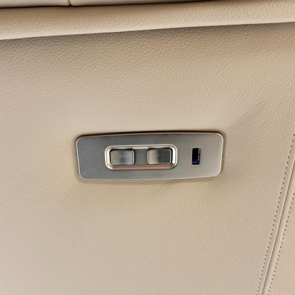 Close-up of the power recliner button on the chair.