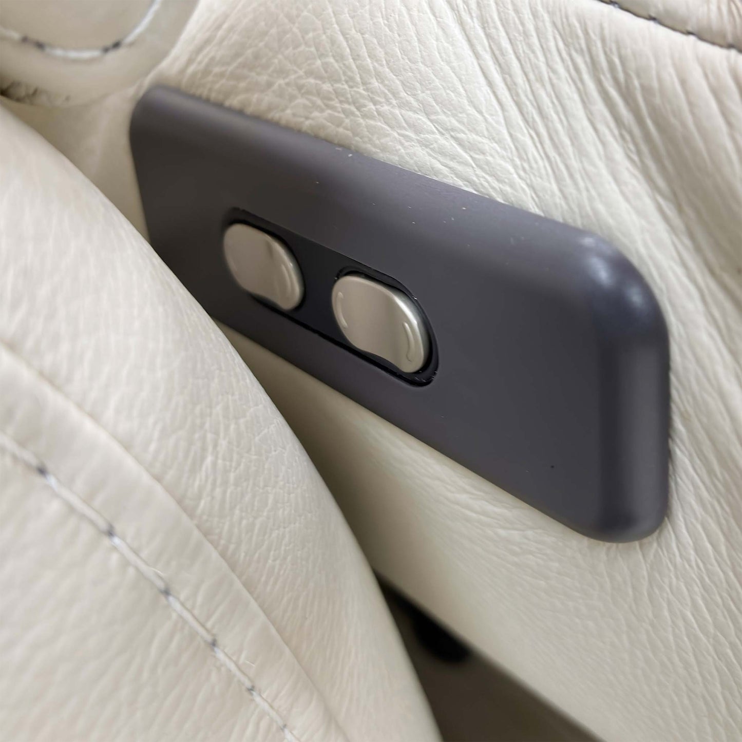 Close-up of the power controls discreetly located on the sofa's padded arm, ready to activate the recliner and headrests.