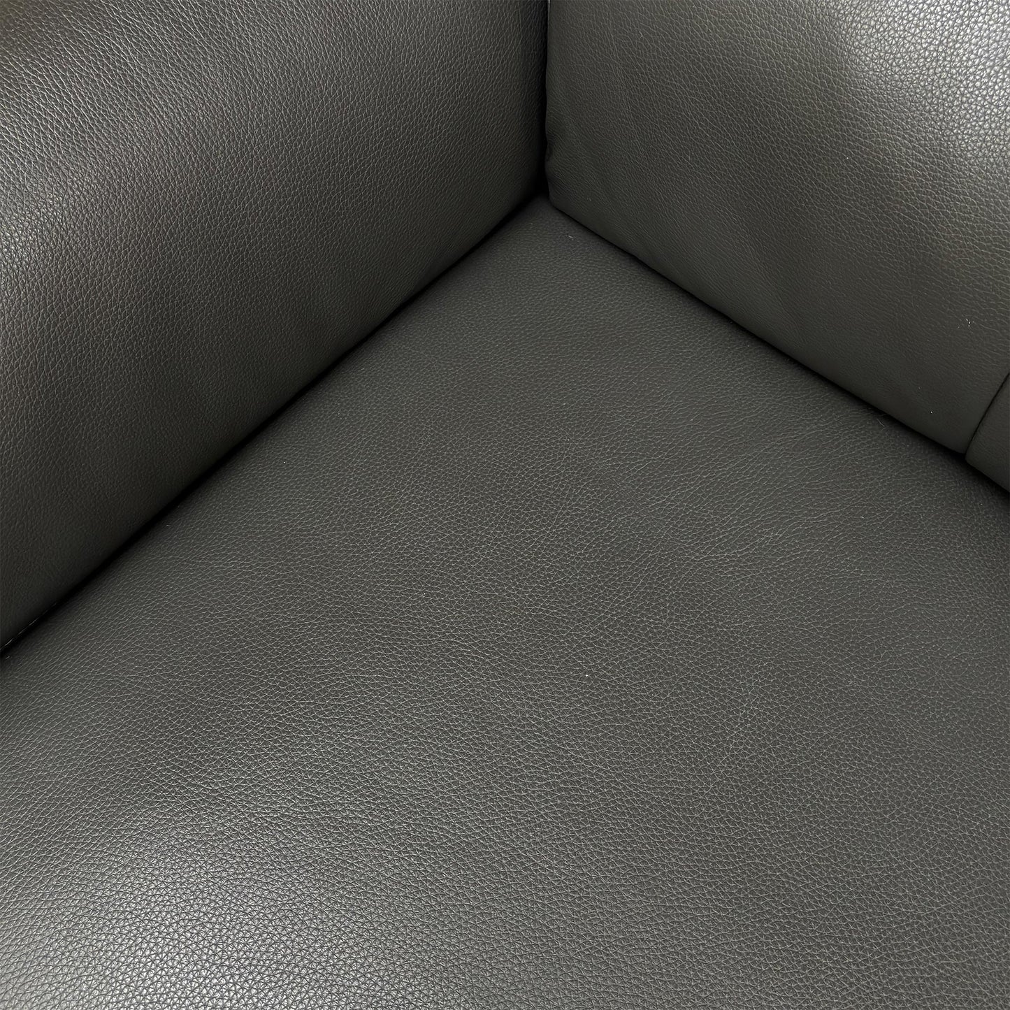 Detailed close-up of the 100% real leather upholstery in Storm Grey, emphasizing its quality and texture.