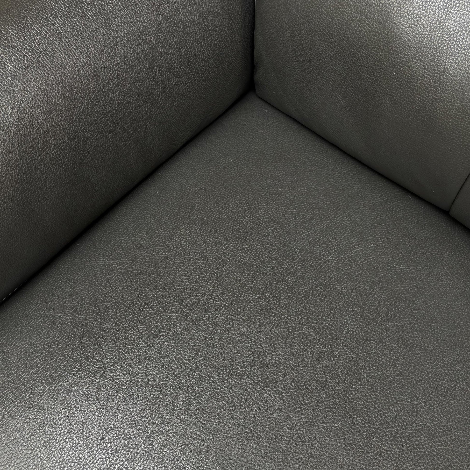 Detailed close-up of the 100% real leather upholstery in Storm Grey, emphasizing its quality and texture.