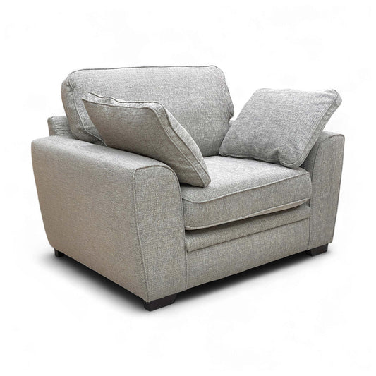 Angled view of the Chalfont Armchair, highlighting the woven silver-grey fabric texture and the large, comfortable cushions.