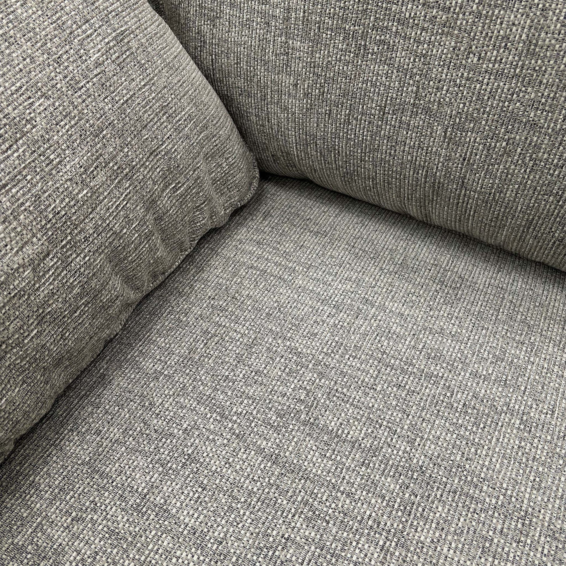 Close-up of the fabric texture on the armrest and cushion.