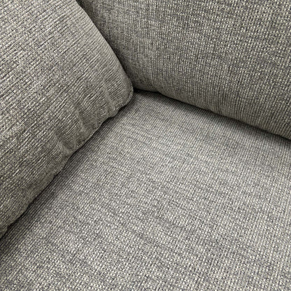 Close-up of the fabric texture on the armrest and cushion.