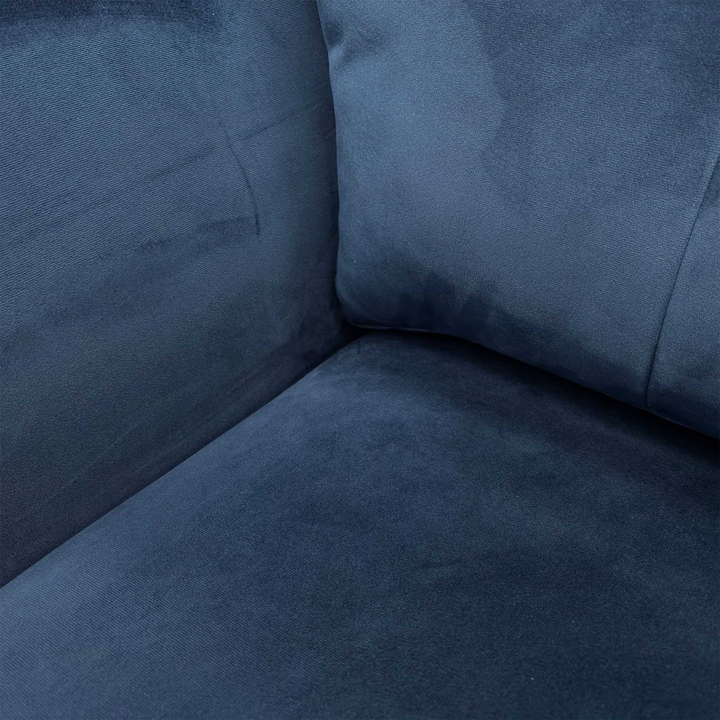 Close-up of the velvet fabric texture and cushion detail.