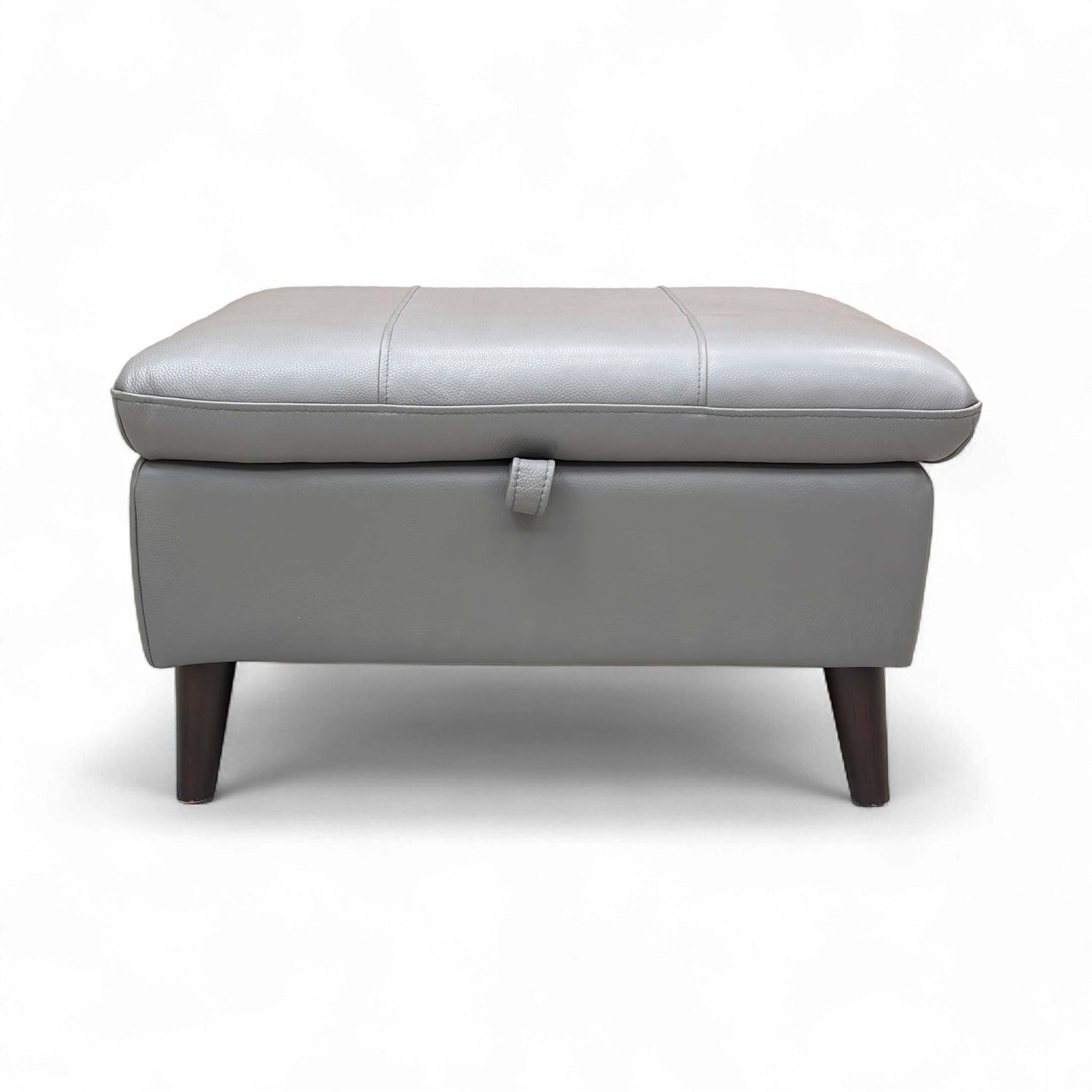 Full view of the 'Winner' Oslo Storage Footstool upholstered in Elephant Leather, resting on tapered wood legs.