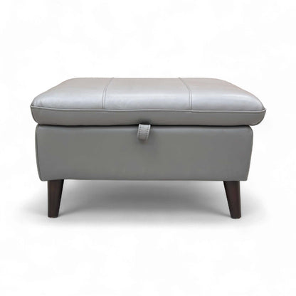 Full view of the 'Winner' Oslo Storage Footstool upholstered in Elephant Leather, resting on tapered wood legs.