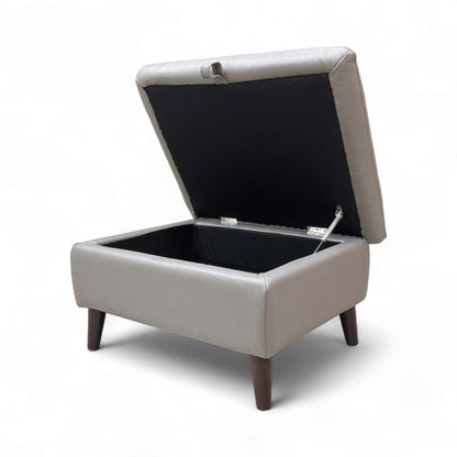 The footstool with the lid open, showing the storage space.